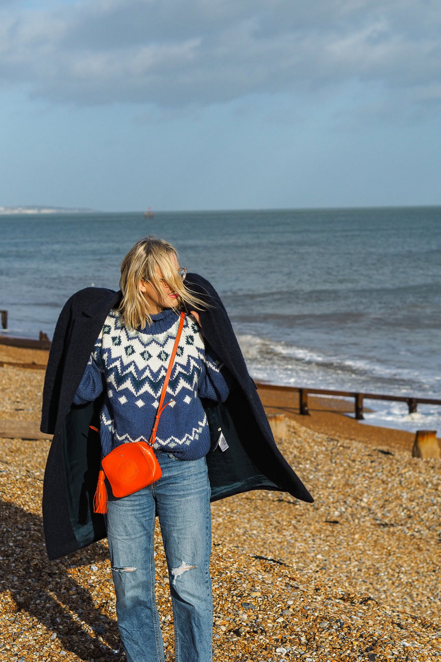 Alexandra Stedman of The Frugality walking along Deal's pebbly beach.